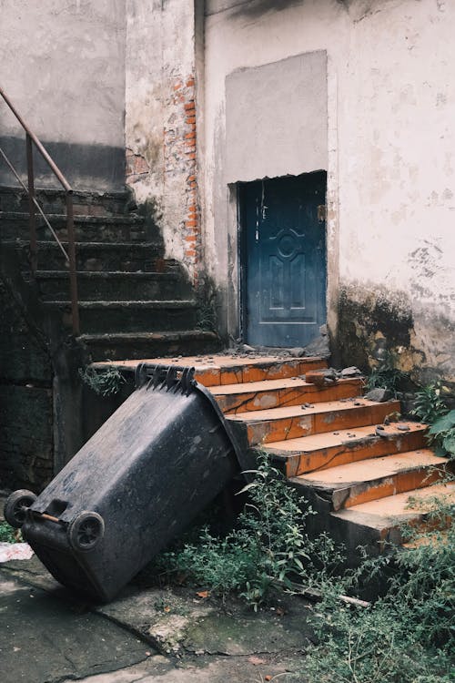 Garbage Bin Lying Down near Stairs