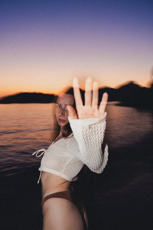 Woman in White Top and Swimsuit Posing on Lakeshore