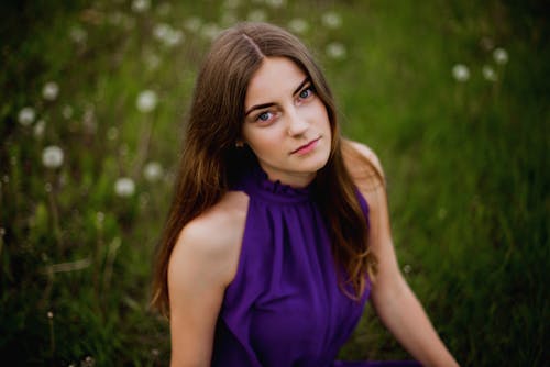 Woman Sitting in Purple Dress