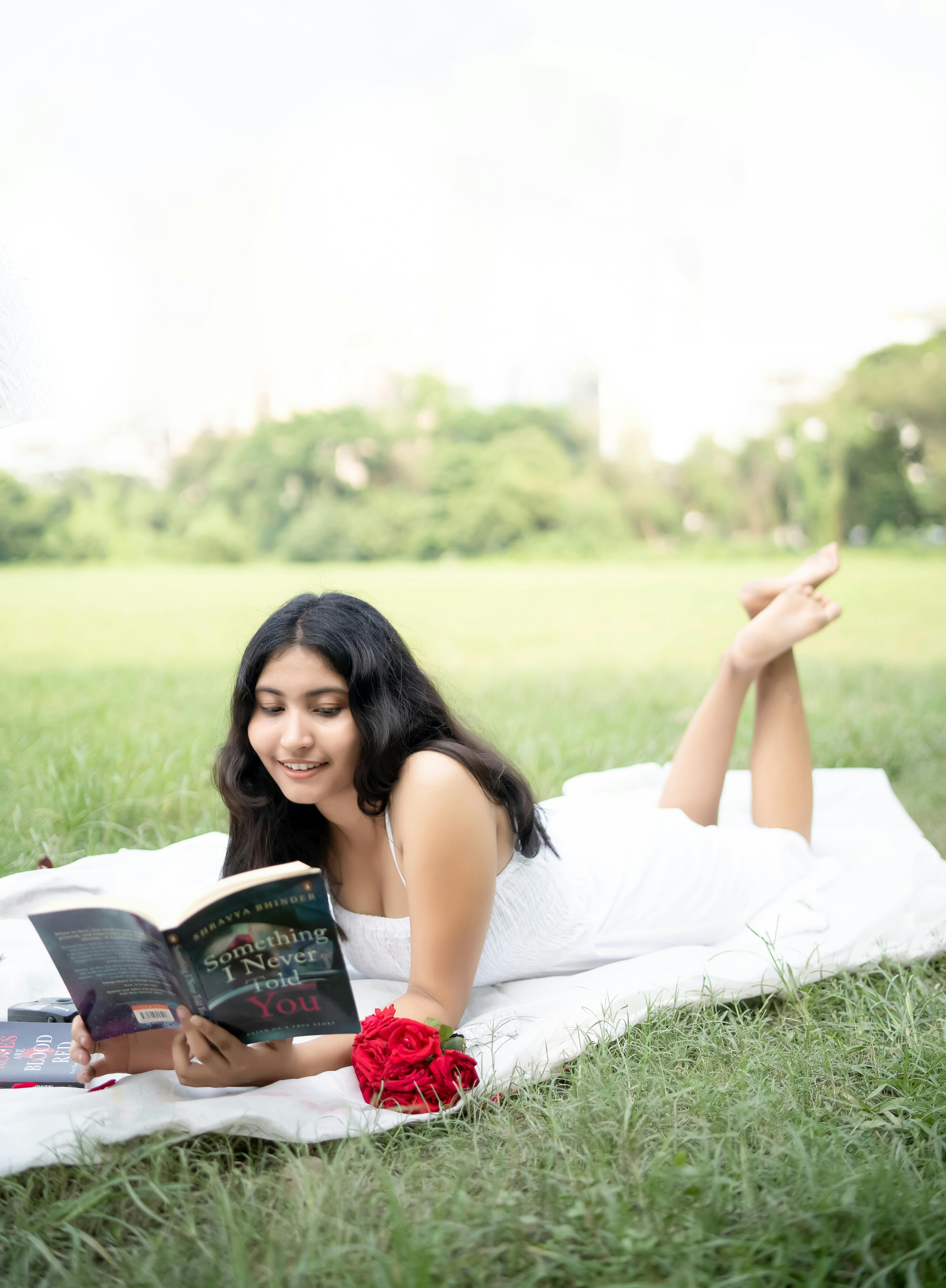 A Woman Looking to Her Friend while Holding a Book · Free Stock Photo