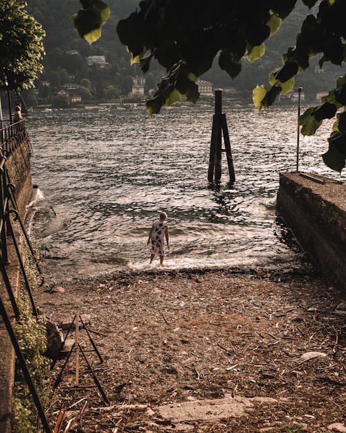 Back View of a Person Walking into Lake Maggiore