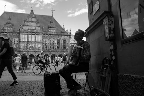 Man Playing on Accordion on a Square in Bremen in Black and White