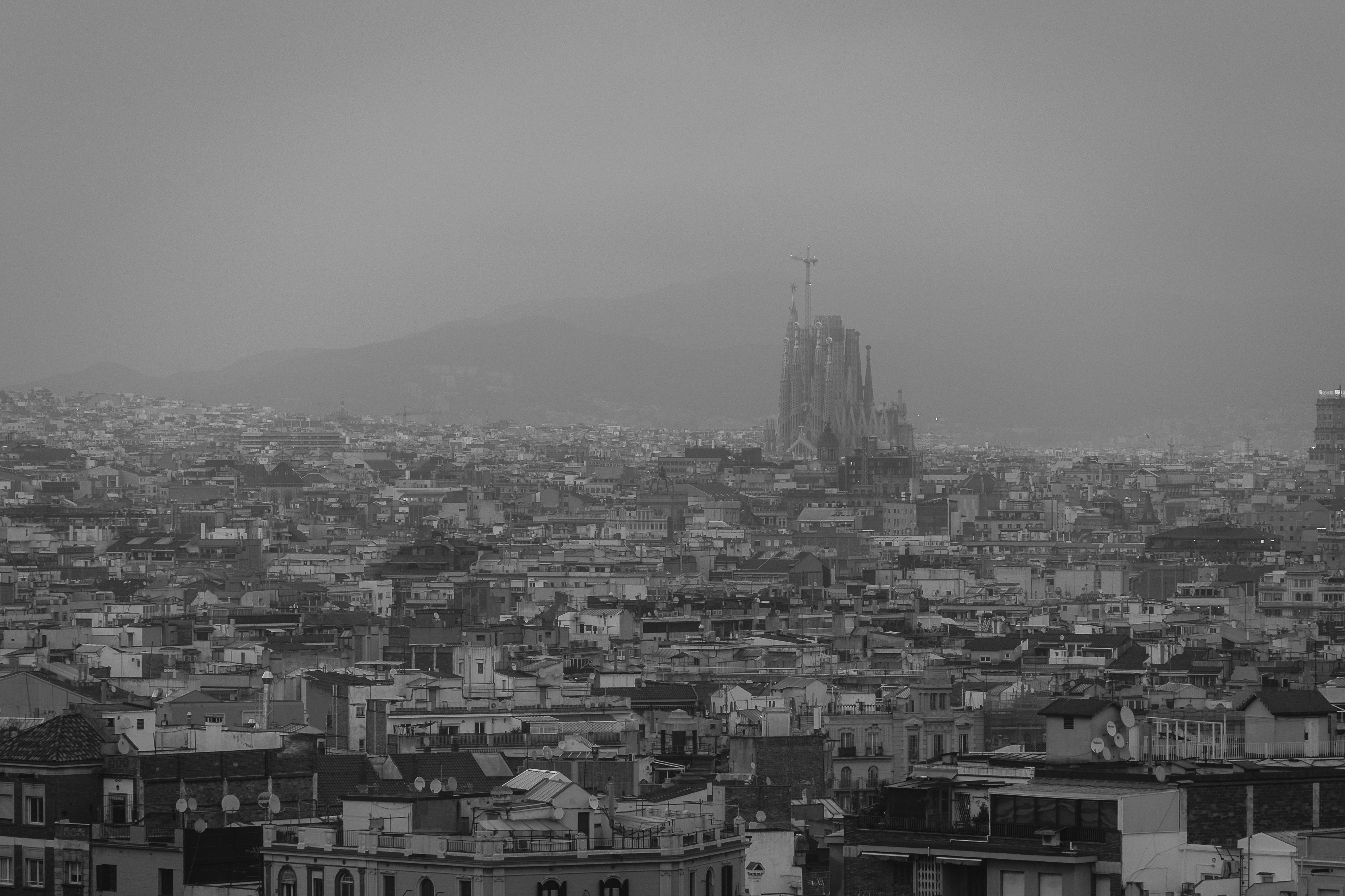 fog over barcelona with la sagrada familia behind