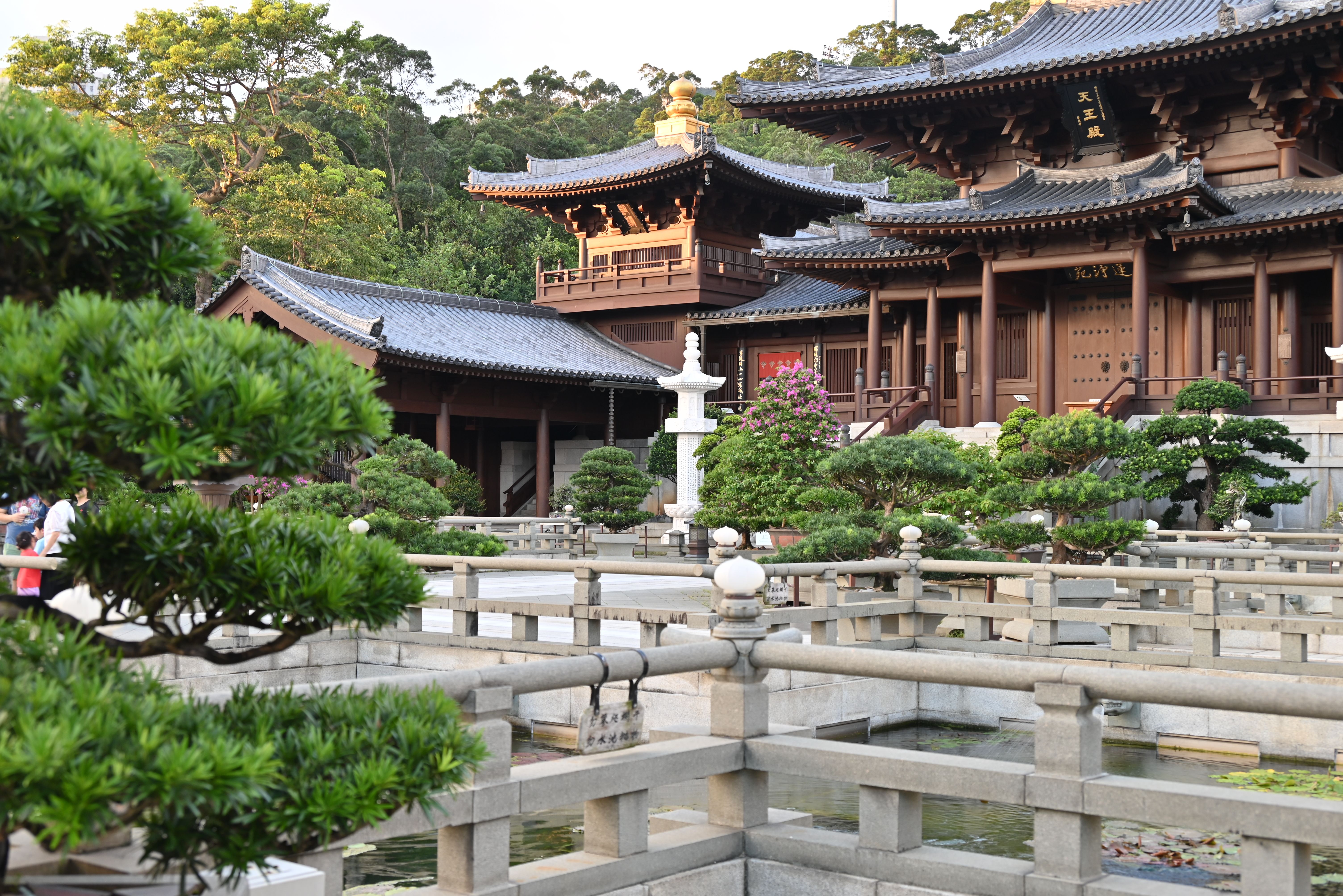 Explore a peaceful temple courtyard showcasing classic East Asian architecture and lush greenery.