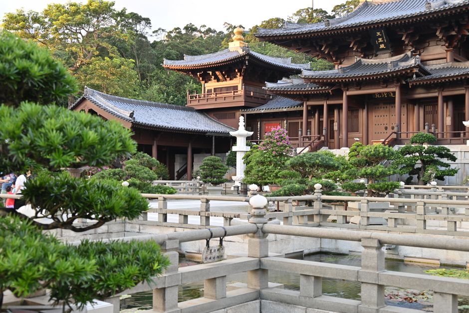 Explore a peaceful temple courtyard showcasing classic East Asian architecture and lush greenery.