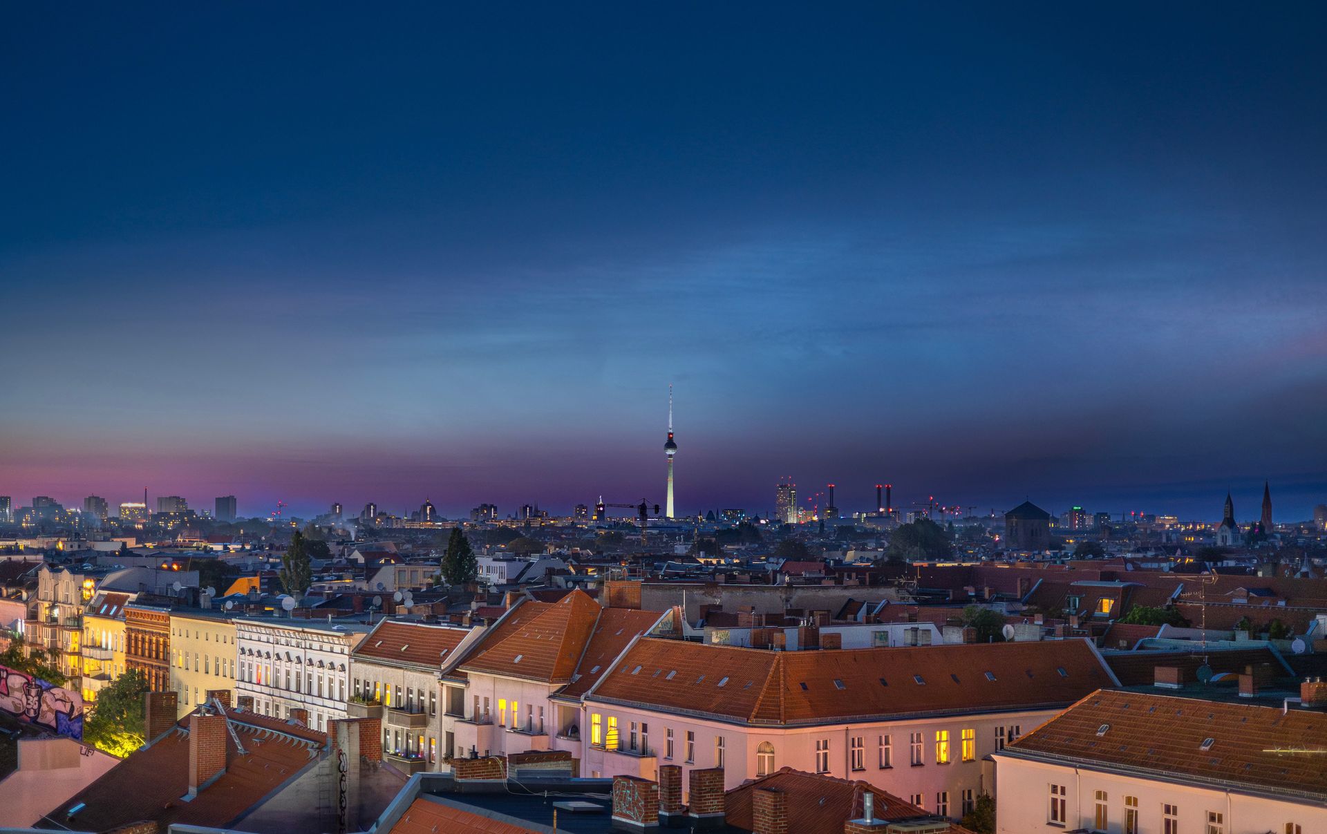 Panoramic view of Berlin skyline featuring the iconic TV Tower during twilight.
