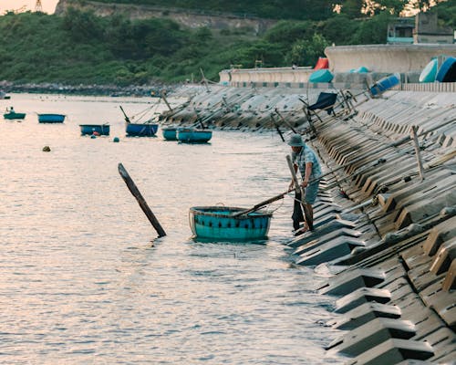 Man Fishing in a Harbor 