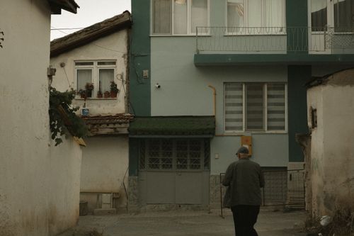 Free An elderly man walks in a quaint street of Merzifon, showcasing traditional architecture. Stock Photo