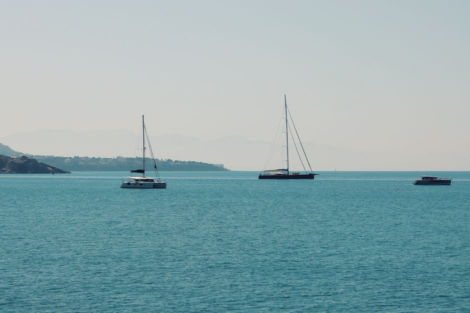 Unforgettable Capri Signature Boat Tour from Amalfi with Time on Land Review 2026 - Tranquil scene of sailboats floating on the blue waters off Cefalù, Sicily.