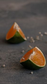 Vibrant citrus fruit slices on gray background, perfect for food photography.