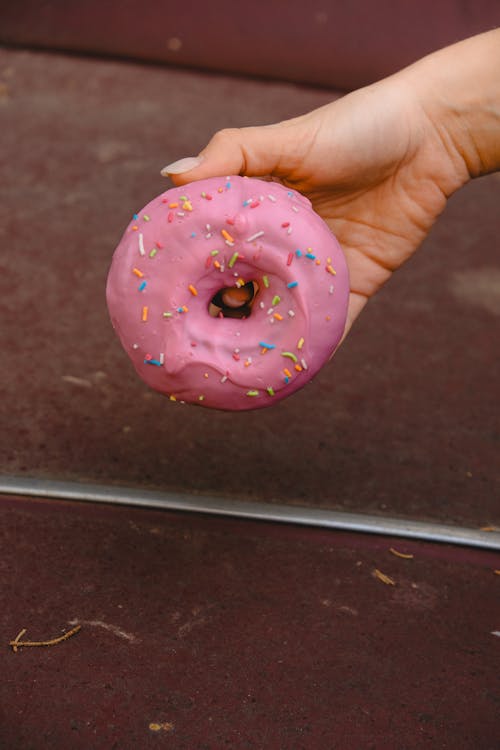 Woman Hand Holding Donut