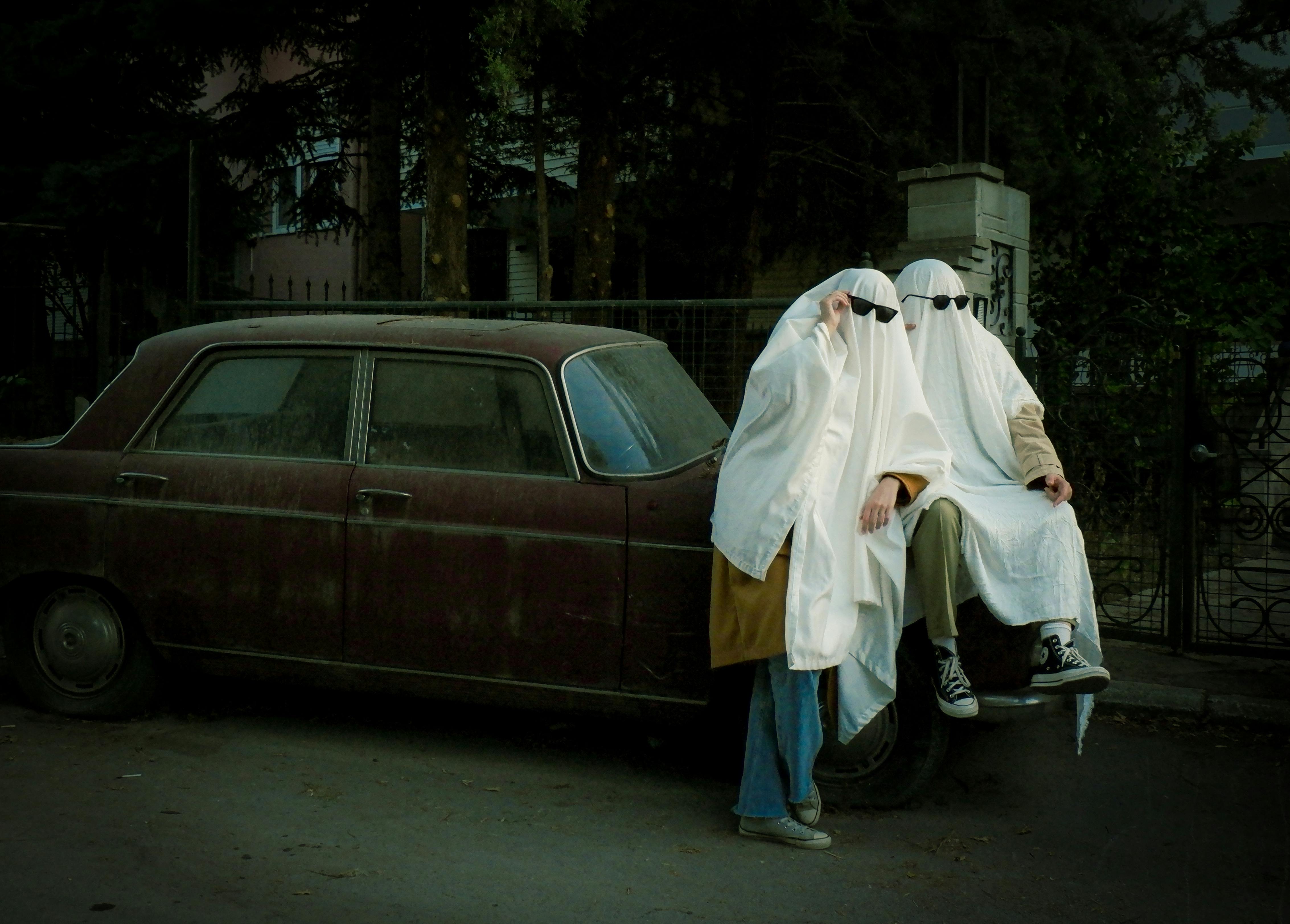 Person in ghost costume dancing on empty foggy road · Free Stock Photo