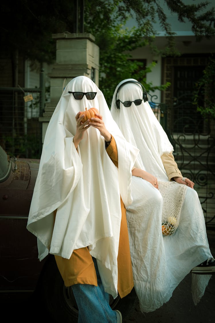 People In Ghosts Costumes Celebrating Halloween