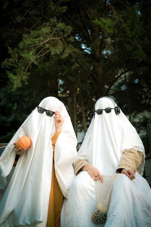 Two People Wearing White Sheets Pretending to be Ghosts