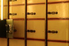 Close-up of vintage postal lockers with keyholes, evoking nostalgia and security.