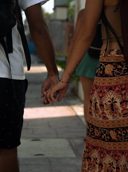 Couple Holding Hands on a Street 