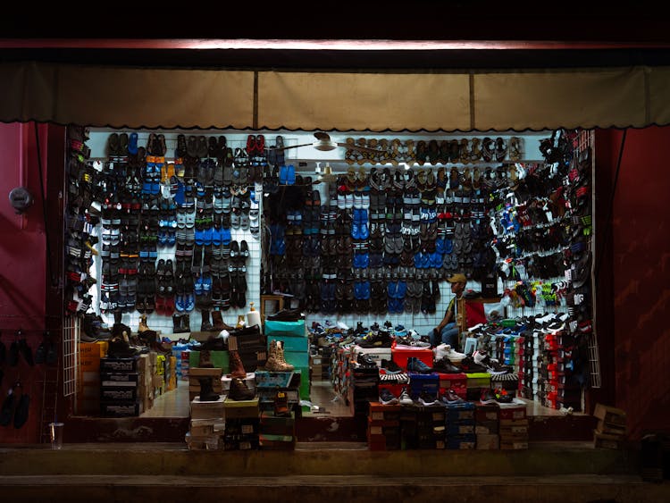 Man Selling Shoes On A Bazaar 