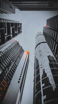 Tall modern skyscrapers with glass reflections in an urban cityscape.