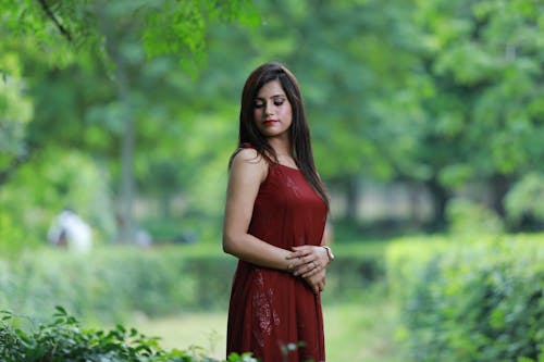 Model Standing in Red Dress