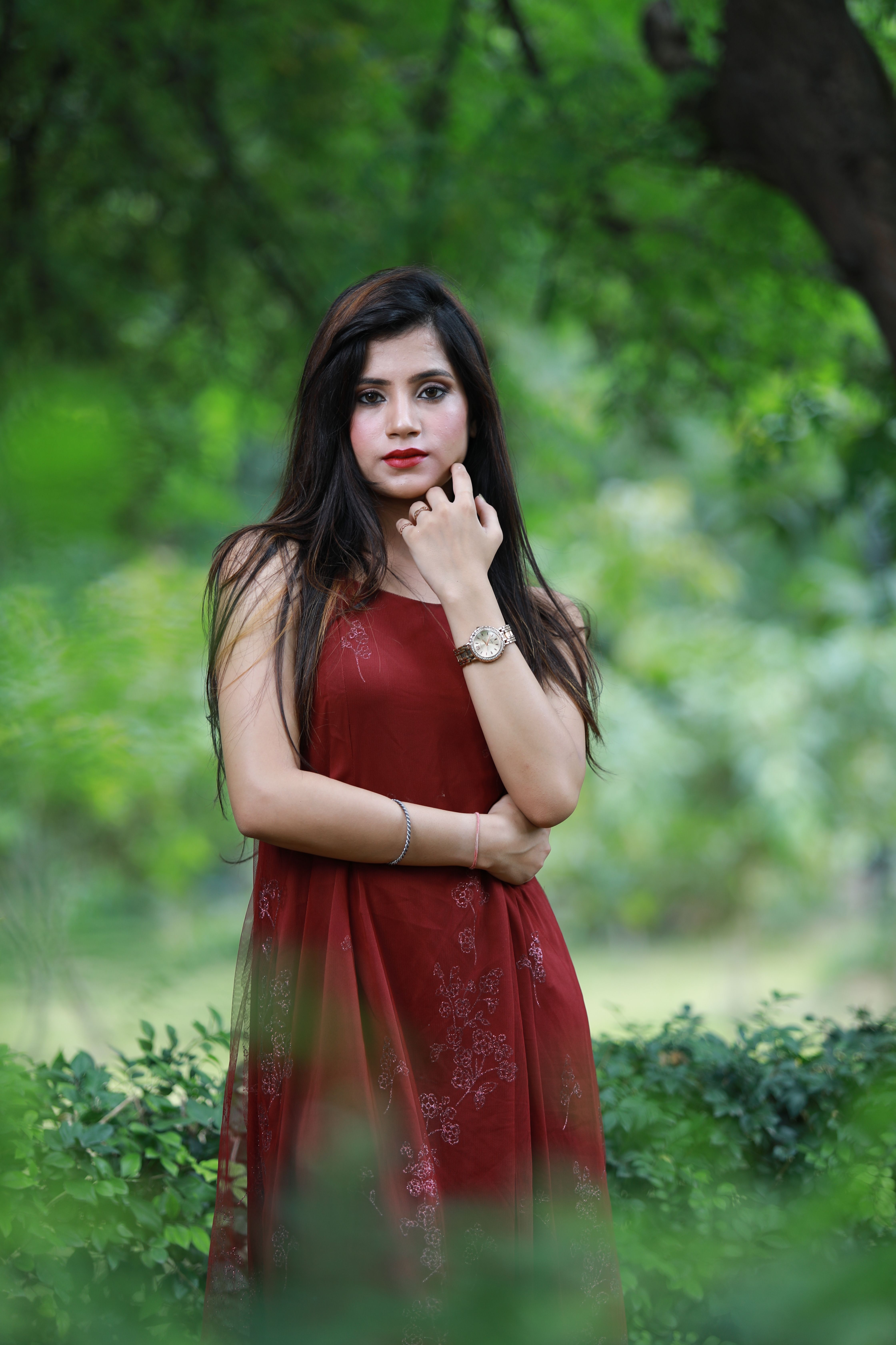 A beautiful young woman in a red dress posing for the camera · Free ...