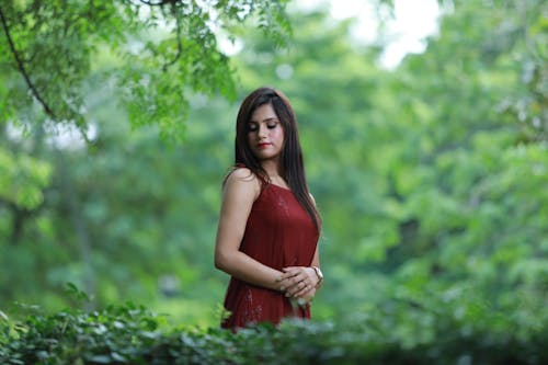 Woman with Black Hair Standing in Red Dress