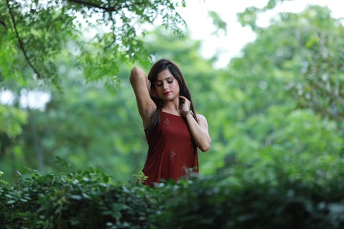 Brunette Woman Standing in Red Dress