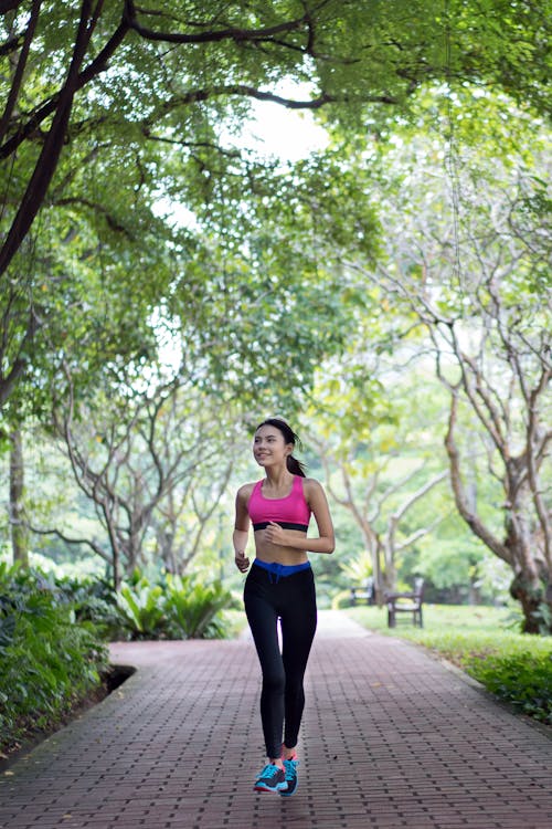 Woman Running On Pathway