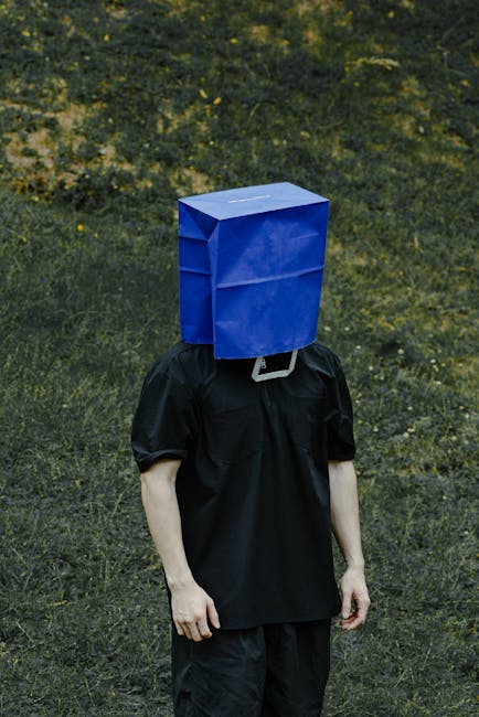 A person with a blue bag on their head stands in a rural outdoor setting in Xiamen.