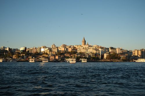 Free Scenic Istanbul skyline with Galata Tower viewed from the waterfront during sunset. Stock Photo