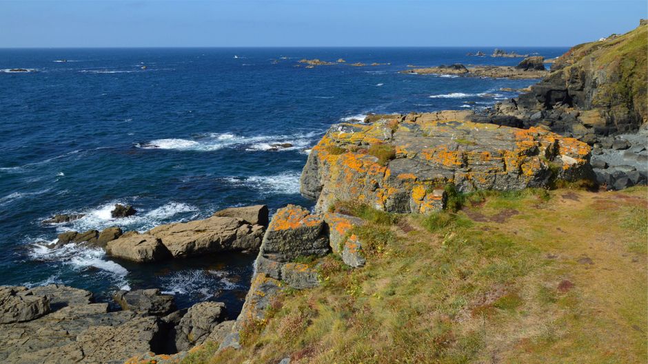 A stunning coastal landscape at Lizard Point, featuring rocky cliffs and deep blue seas.