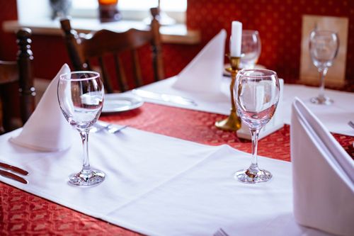Free Sophisticated table setting with wine glasses and candles in a cozy restaurant. Stock Photo