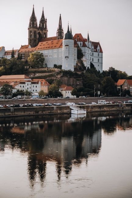 A stunning view of the historic Albrechtsburg Castle in Meissen, reflected in the Elbe River, Germany.