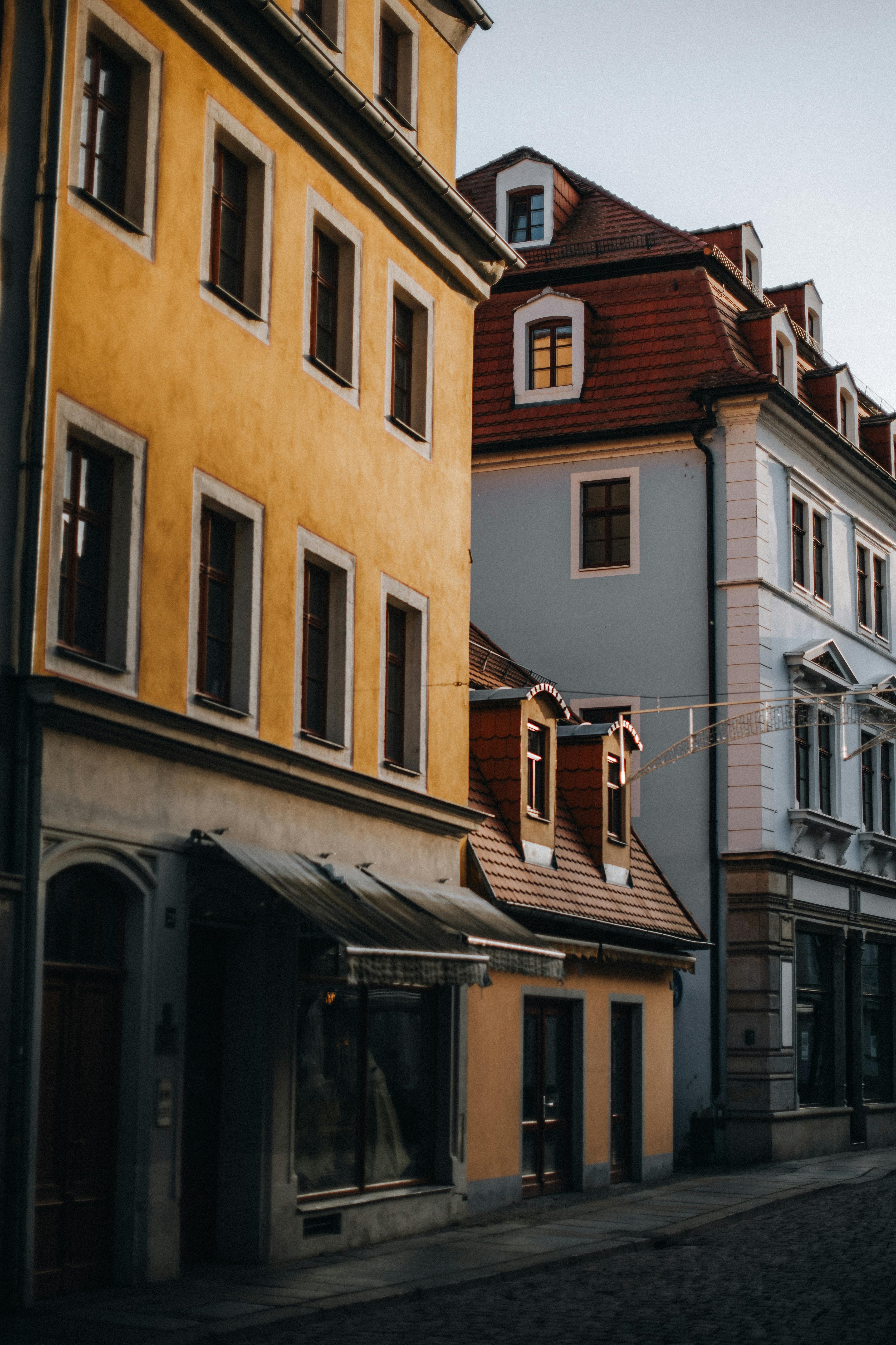 Scenic view of a quiet European street lined with historic buildings at dusk.