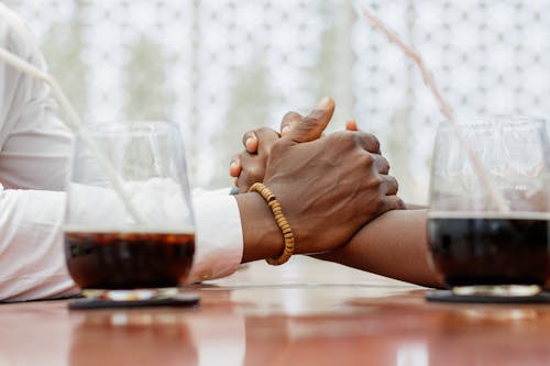 Couple in a Restaurant Holding Hands 