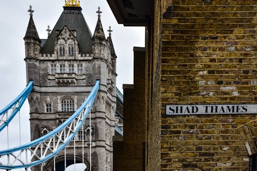 Iconic view of Tower Bridge and Shad Thames in London, showcasing historic architecture.
