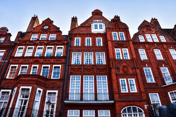 Row of red-brick townhouse facades, photo by AXP Photography on Pexels