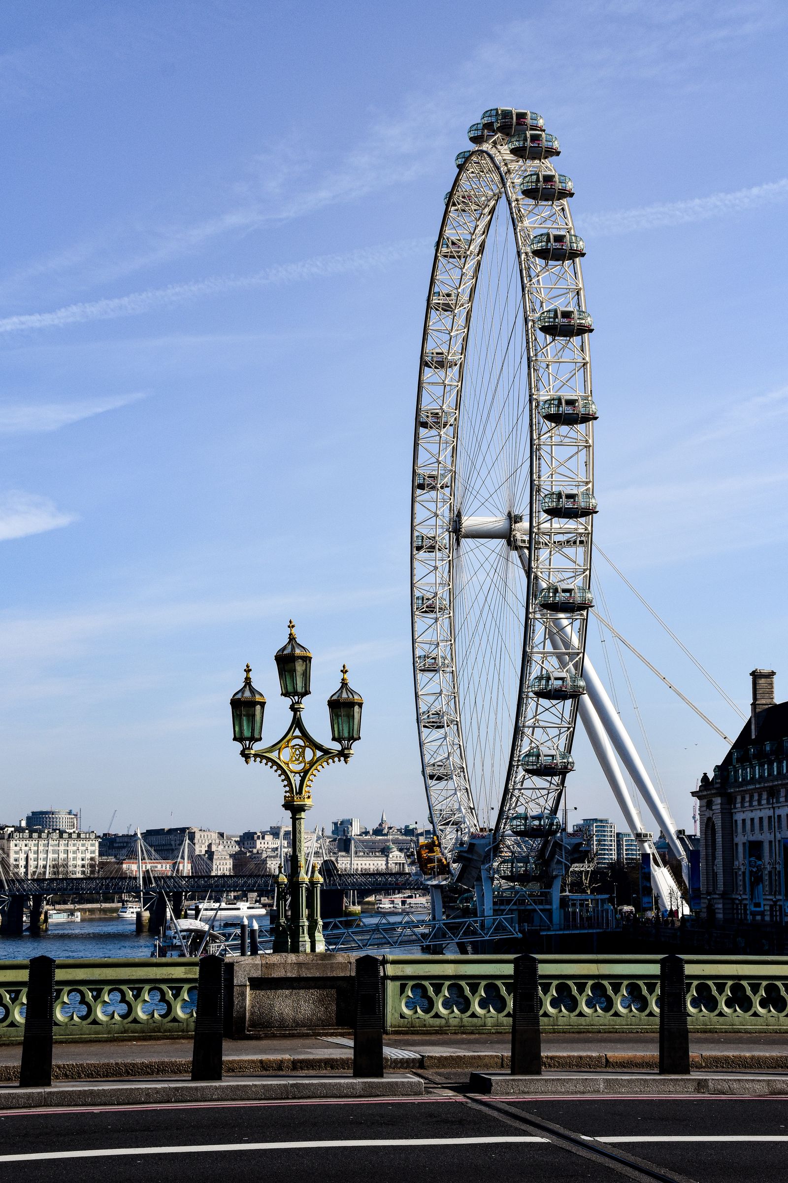 The London Eye's glass capsules turning against a bright blue sky