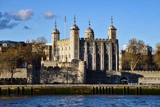 Stunning view of the Tower of London with a clear blue sky, capturing the historic landmark's details.