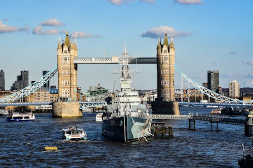 View of the HMS Belfast on River Thames with the Tower Bridge in the Background in London, England, UK 