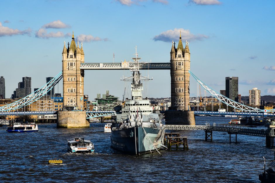 View of Tower Bridge and HMS Belfast in London on a sunny day.