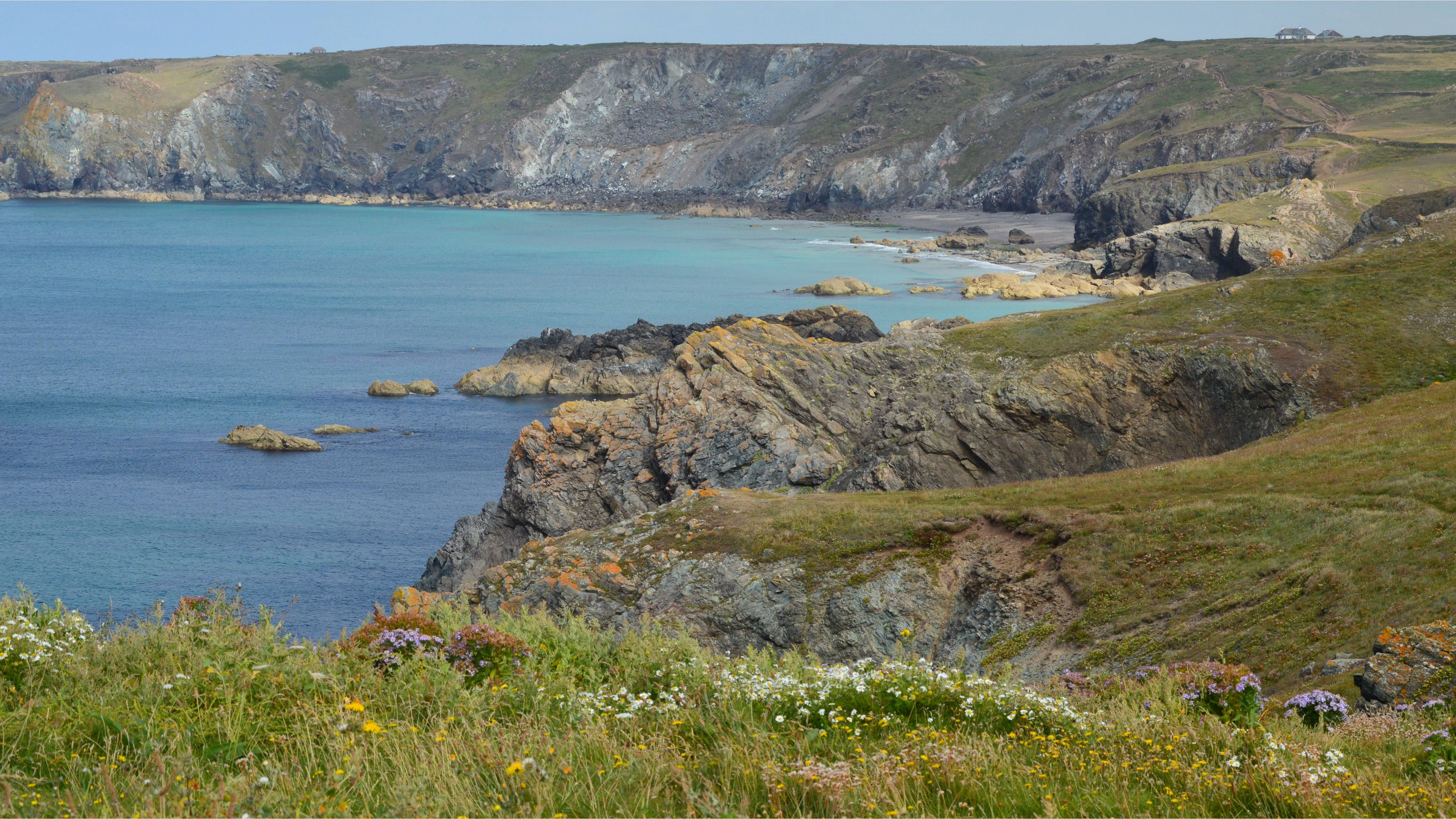 Breathtaking view of a rocky coastline with cliffs and clear blue sea.