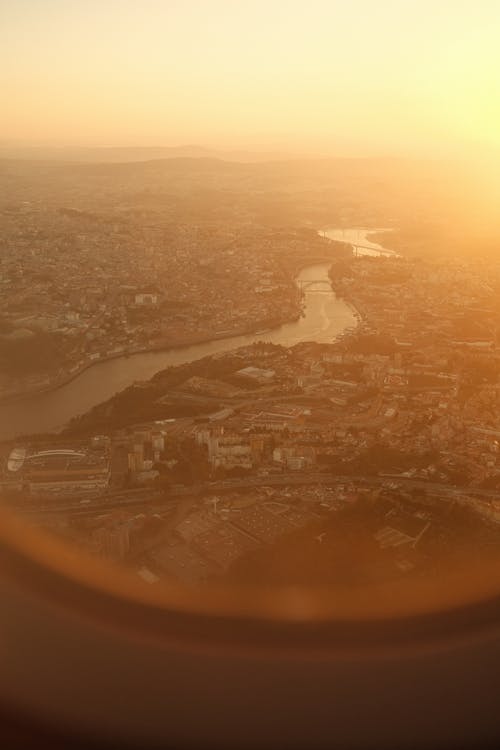 View of a City and River from an Airplane Window 
