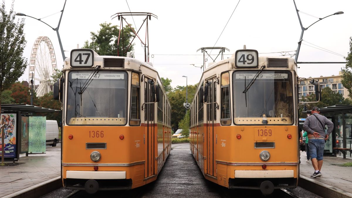 Classic yellow trams in Budapest, Hungary, showcasing urban street life and city transport.