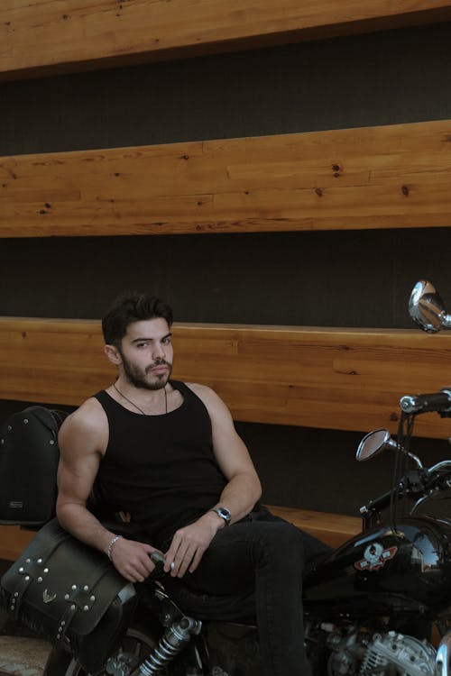 Man in Tank Top Sitting on Motorcycle