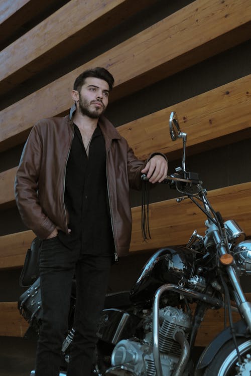 Model in Jacket Standing by Motorbike