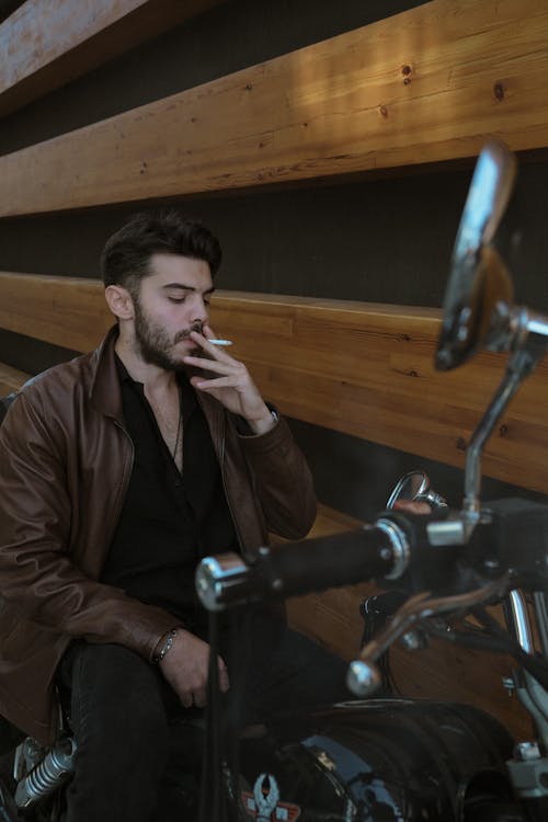 Man Smoking Cigarette on Motorbike