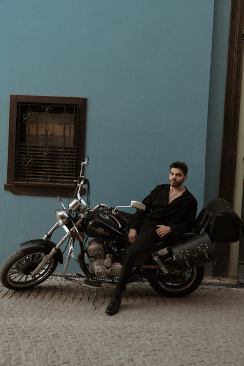 Man in Black Shirt Sitting on Motorbike on Street