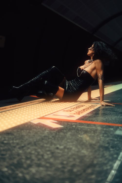 Brunette Model Sitting and Posing on Platform on Subway Station