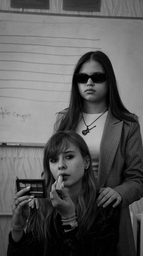 Free Stylish black and white image showcasing two models in a classroom setting. Stock Photo