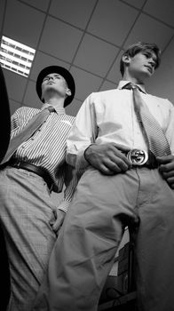Two men in elegant attire, showcasing vintage fashion style with shirts and ties.